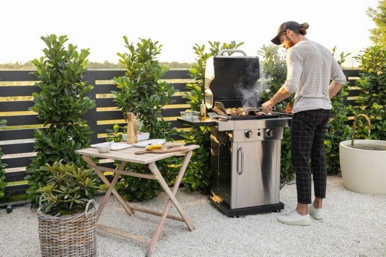 Man Cooking On A Grill Outdoors