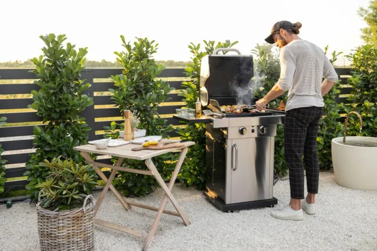 Man Cooking On A Grill Outdoors