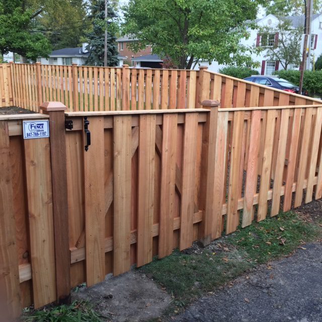 A wooden fence in a residential neighborhood.